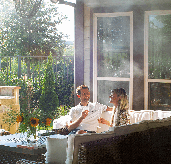 Patio misters cooling an outdoor seating area for relaxing